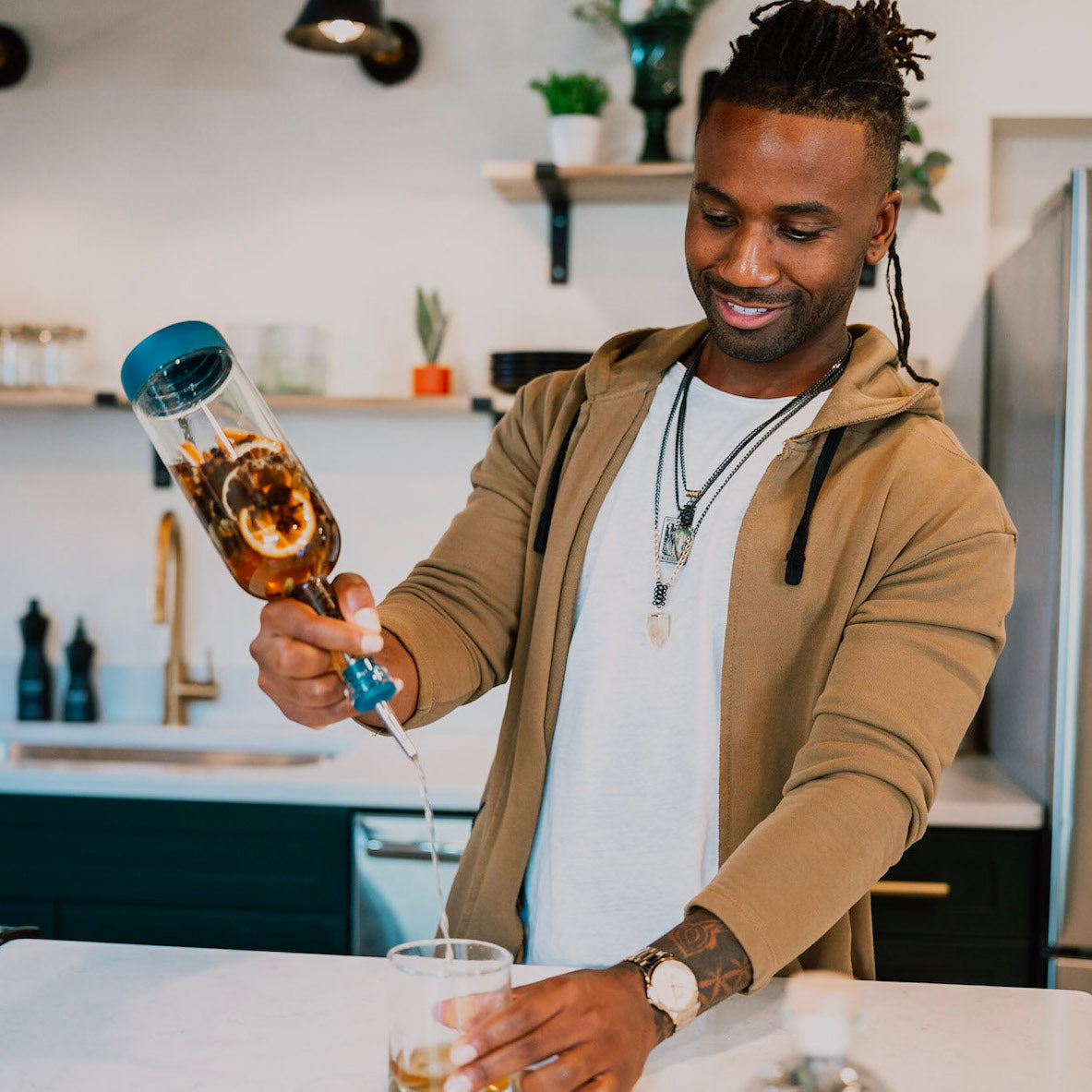 Man using cocktail kit to create craft cocktail at home