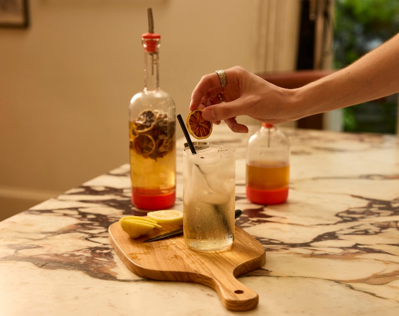 Person creating a drink with a cocktail set