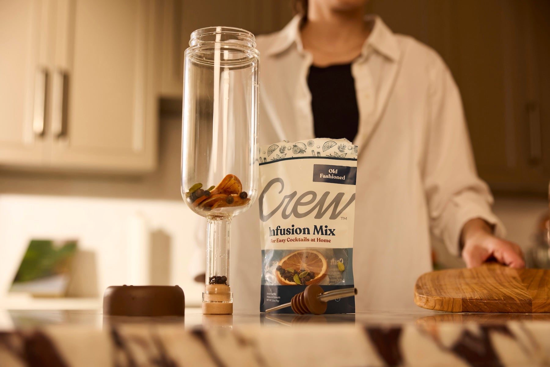 A person using an Old Fashioned cocktail kit/cocktail set for home bartenders