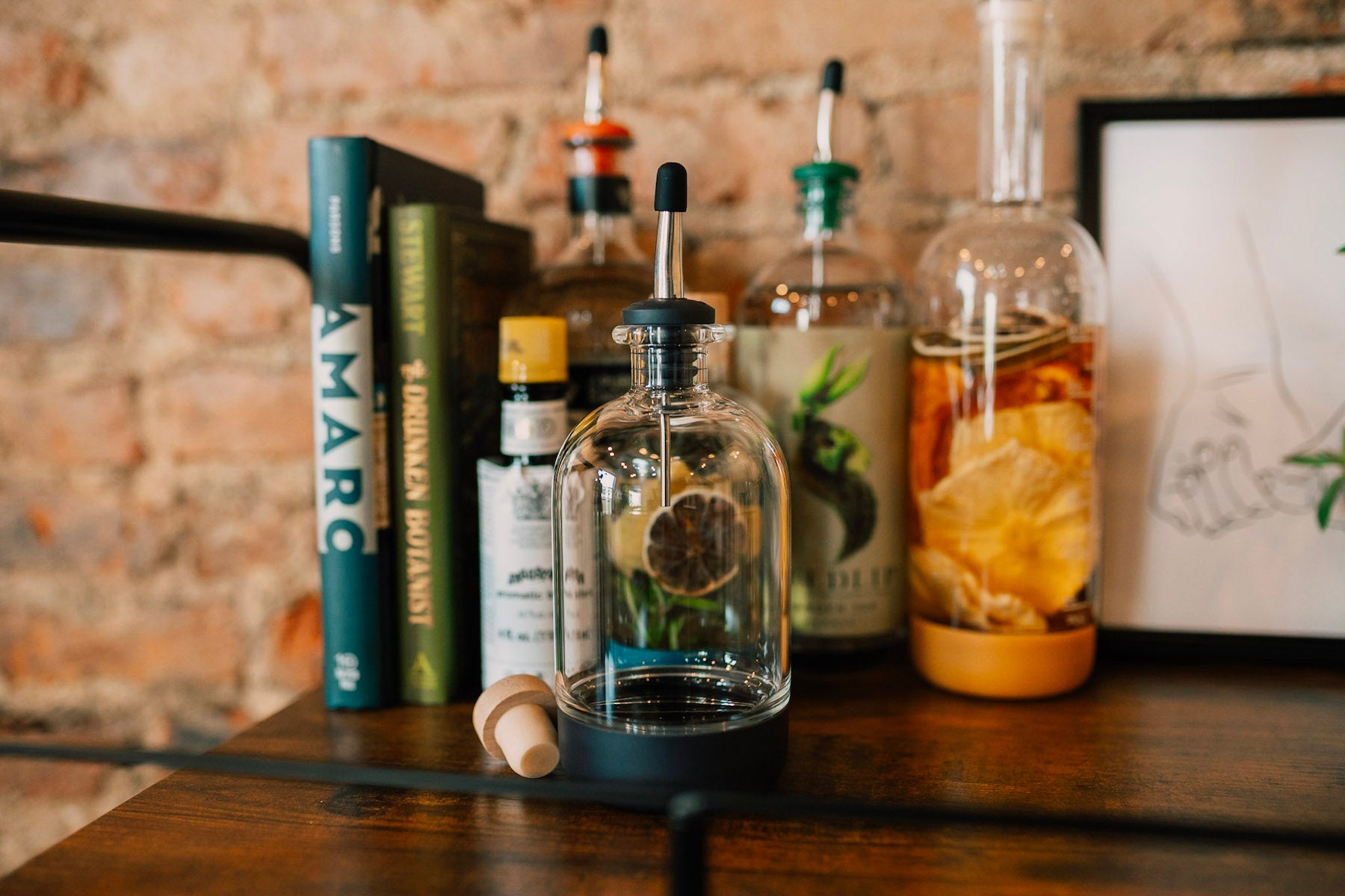 Home mixology infusion bottles on a bar cart. Infusion bottles also make great gifts for coworkers.